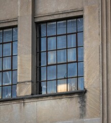 Gray stone building with old glass windows.