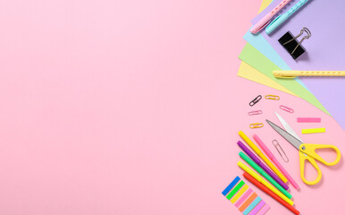 Back to school concept. Different stationery items for school on a pink background. View from above, copy space