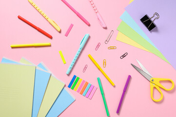 Back to school concept. stationery items for school on a pink background. View from above