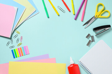 Stationery on a blue background. Flat lay, copy space
