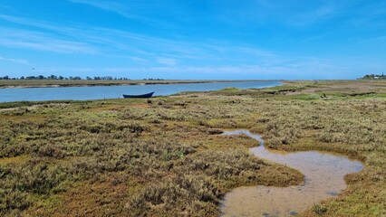 Scenic view of a boat near a lake in Ria Formosa nature reserve in Portugal