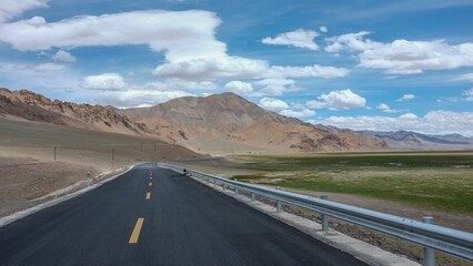 Beautiful view of the road against mountains and a cloudy sky