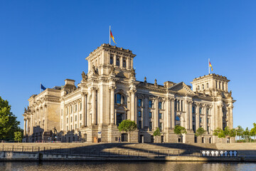 Fototapeta na wymiar View across the River Spree of the historic Reichstag building in the city of Berlin, Germany.