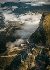 Aerial view of Serra da Leba road winding through a mountainous landscape - obrazy, fototapety, plakaty
