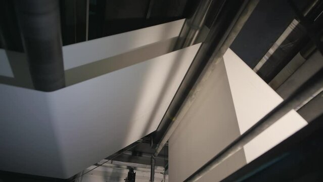 The white paper is getting transported by a printing press.
