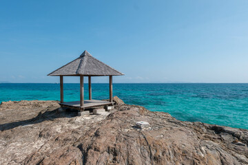 Beautiful scenery pavilion on rock coast with blue sea ocean water and sky, scenic tropical outdoor landscape coastline travel in summer with horizon bay wave, tourism sun and sunrise asia landmark