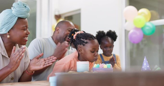 Birthday, kids and party for blowing candles with black family in celebration of girl child in their home. Parents, grandparents and children clapping with applause around a cake at a milestone event