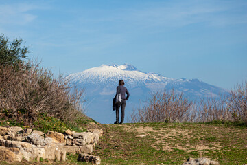 A tourist watch the Etna volcano