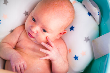 A newborn baby takes a bath. A lovely child is undergoing military training for the first time. The concept of children and hygiene