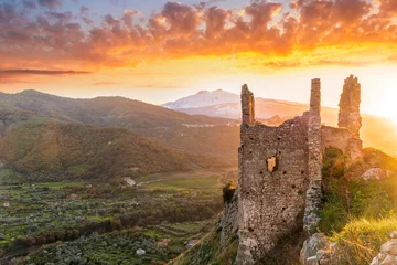 Crédence de cuisine en verre imprimé Cappuccino beautiful sunset or sunrise landscape of ancient ruins on a top of a hill with green mountains with white snow top on background