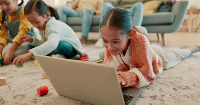Happy, playing and child with a laptop for cartoon streaming, games or education on the floor. Smile, home and a girl kid typing on a computer for learning or communication in the living room