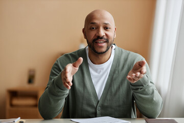 Minimal front view portrait of black man talking animatedly at camera, copy space