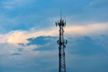 Microwave transmission tower on the background of water logged clouds in the sky
