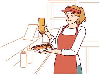 Woman prepares hot dog working as seller in street food cafe or restaurant on wheels