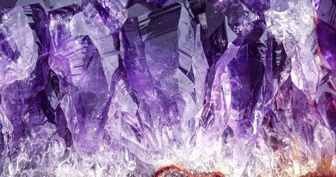amethyst rotating in 4k. macro detail texture background. close-up raw rough unpolished semi-precious gemstone