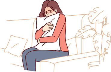 Frightened woman hugging pillow sitting on couch feeling fear and depressed psychological state