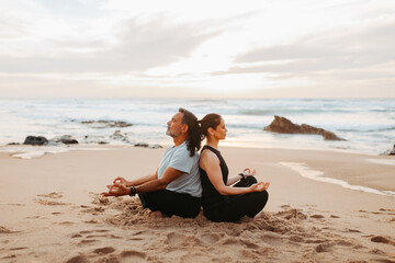 Calm senior caucasian family in sportswear practice yoga and breathing exercises, enjoy training, rest and relax