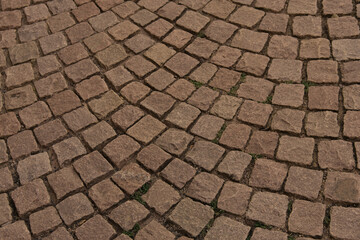 Closeup rough basalt texture of old medieval stone road, brown natural backdrop, stone, bridge road, pavement, pattern, texture, fragment of historical floor covering, copy space