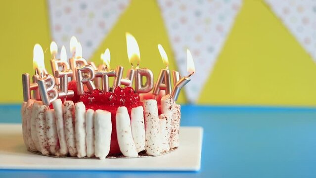 Birthday cake. Cake with burning candles on a bright background. Happy birthday! Festive cake on a festive background with flags