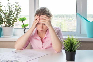 woman frustrated, upset by utility bills, bank debts, mortgage, bankruptcy, poverty, employee...