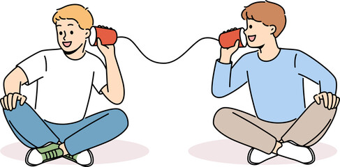 Smiling boys talk on tin can phone