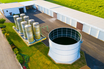 Fertilizer warehouse in the middle of green fields. Modern agriculture in the European Union from above. - 619081051