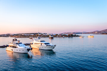 The port of Antiparos in the evening, with Paros Island in the background. Cyclades Islands, Greece.