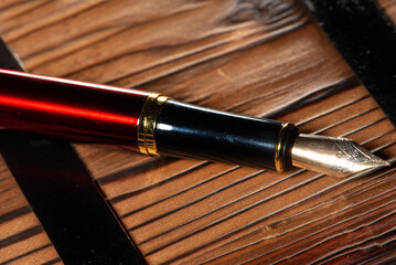 Fountain pen, beautiful details of a fountain pen on rustic wood, selective focus.