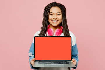 Young IT woman of African American ethnicity wear white sweatshirt casual clothes hold use work on blank screen workspace area laptop pc computer isolated on plain pastel light pink background studio.