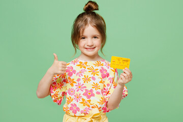 Little child kid girl 6-7 years old wear casual clothes have fun hold in hand mock up of credit...