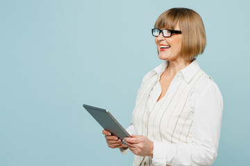 Side view smiling fun employee business woman 50s wear white classic suit glasses formal clothes...