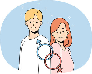 Smiling man and woman with gender identity signs