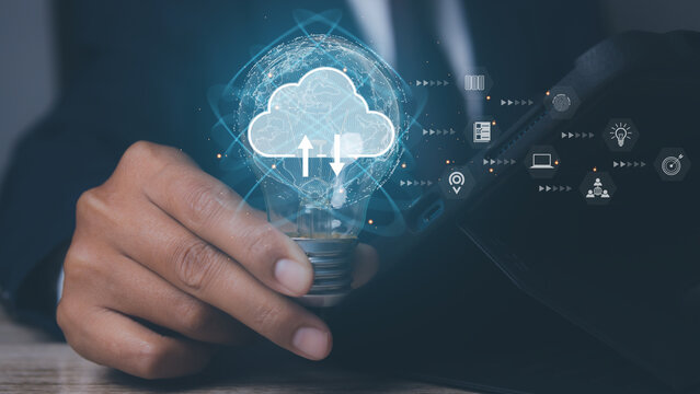 Business hand using light bulb with  cloud computing technology. Storage and data transfer Cloud network , Cloud technology. Networking and internet service concept.