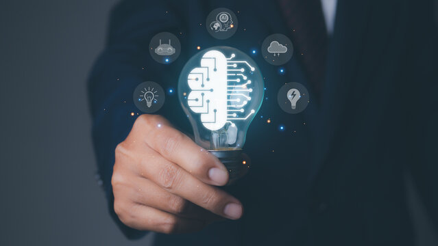 Brainstorming creative idea and innovation. Businessman holding light bulb with brain icon of idea, Brainstorm, Innovation and digital transformation change management, internet of things.