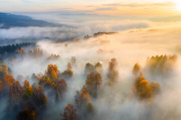 Foggy Autumn Morning in a Valley Surrounded by Hills and Mountains