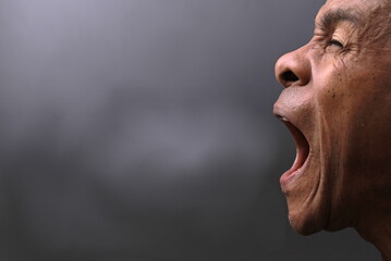 man shouting with anger mental health on grey background with people stock photo 