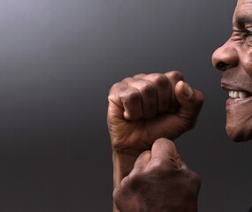 man praying to god with hands together with depression on grey background stock photo	