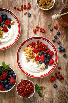 Yogurt With Berries On Wooden Background. White Plain Greek Yogurt With Fresh Berries And Granola, Top View. Healthy Food, Breakfast Menu