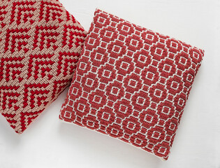 Bright crochet pillows with abstract ethnic pattern on a white background. Crochet piloows with mosaic pattern. Top view.