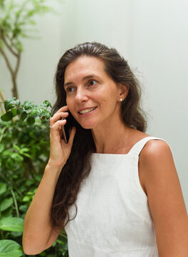 Portrait Of 40 Years Old Russian  Business Woman Without Make Up Talking On The Phone