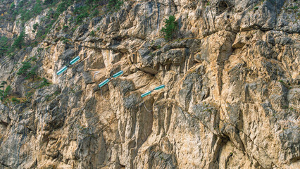 Power lines on the background of a mountain peak. Electrical networks. Wires for the transmission of electricity are laid among the mountain peaks.