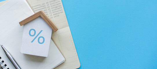 close up house model with percentage on blue background for interest rate of home loan and...