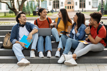 Campus Life. Cheerful multiethnic college students resting outdoors between classes