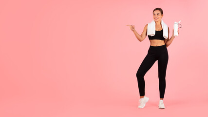 Fototapeta na wymiar Sport Ad. Athletic Young Woman In Activewear Pointing Aside At Copy Space