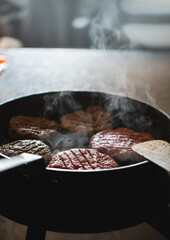 Frying pan with burgers / hamburger patties on high heat, home cooking cheeseburgers