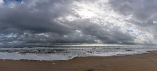 Panoramic View of Large Storm Clouds over Empty Beach