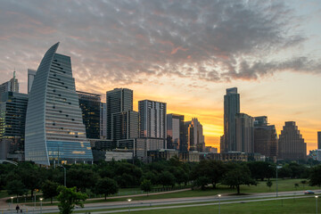 Downtown Austin at Sunrise with bright Yellow Sun in behind the Buildings