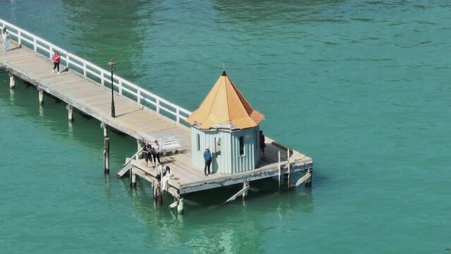 Aerial: Wharf in seaside town of Akaroa, Canterbury, New Zealand