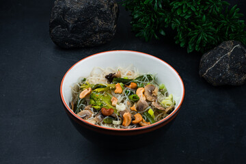 Glass noodles with mushrooms, green beans, onions, broccoli and cashews.