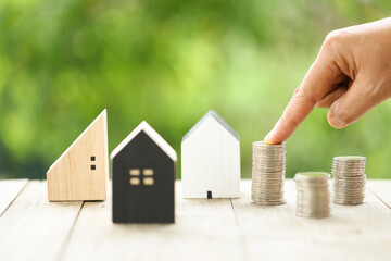 Successful Home Loan Investment with Hand Holding Coins on Nature Background - Wealth and Growth Concept. Financial Success in Real Estate Hand Representing Home Loan and Investment.